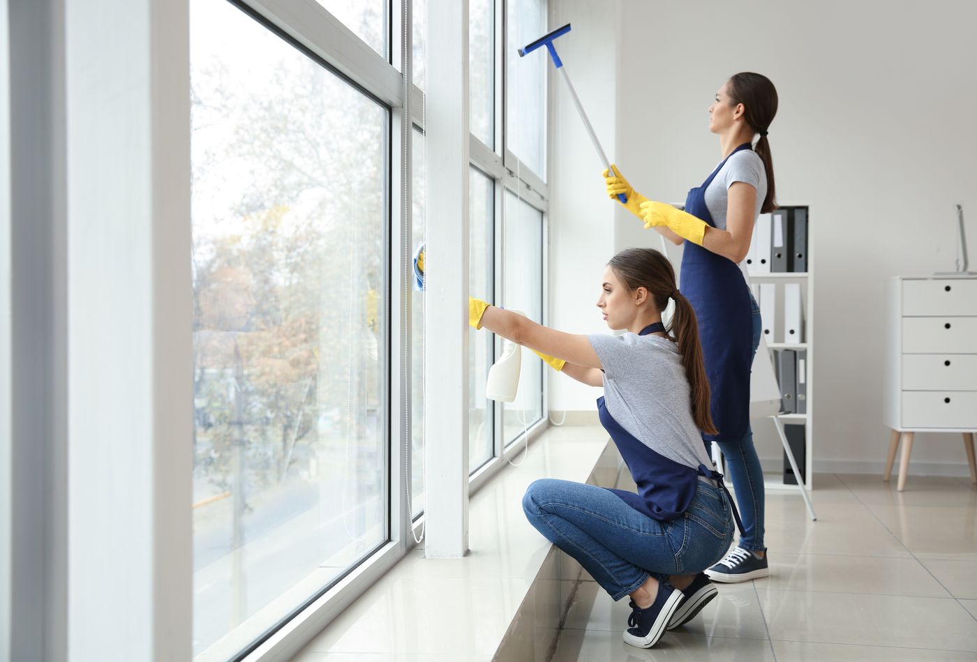 Henry's Pressure Washing team cleaning large windows